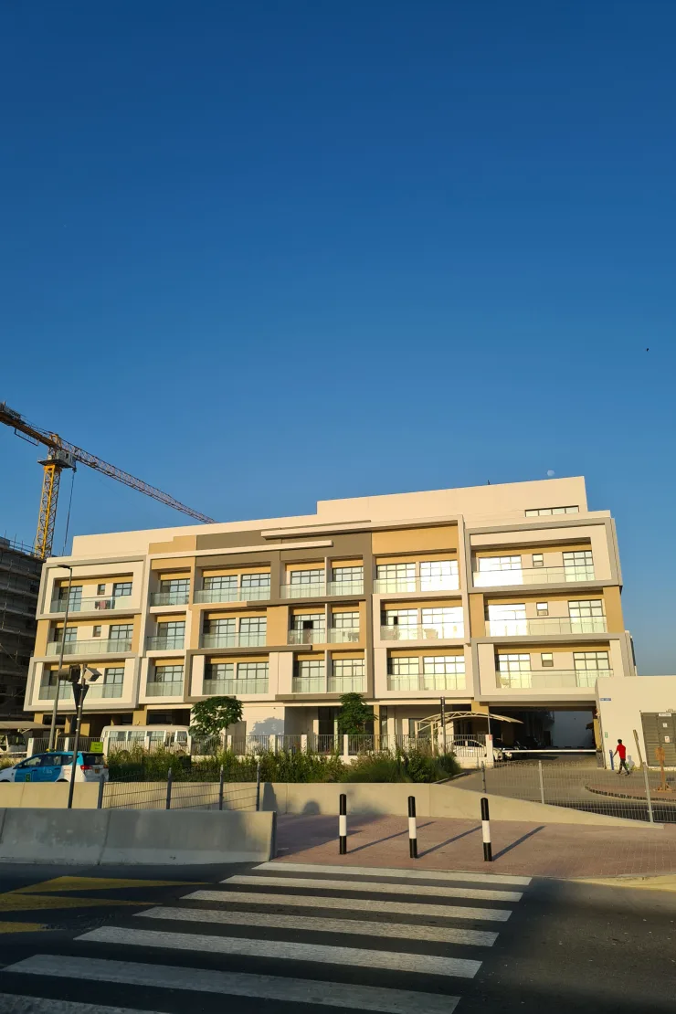 Five-storey beige residential block seen from the street