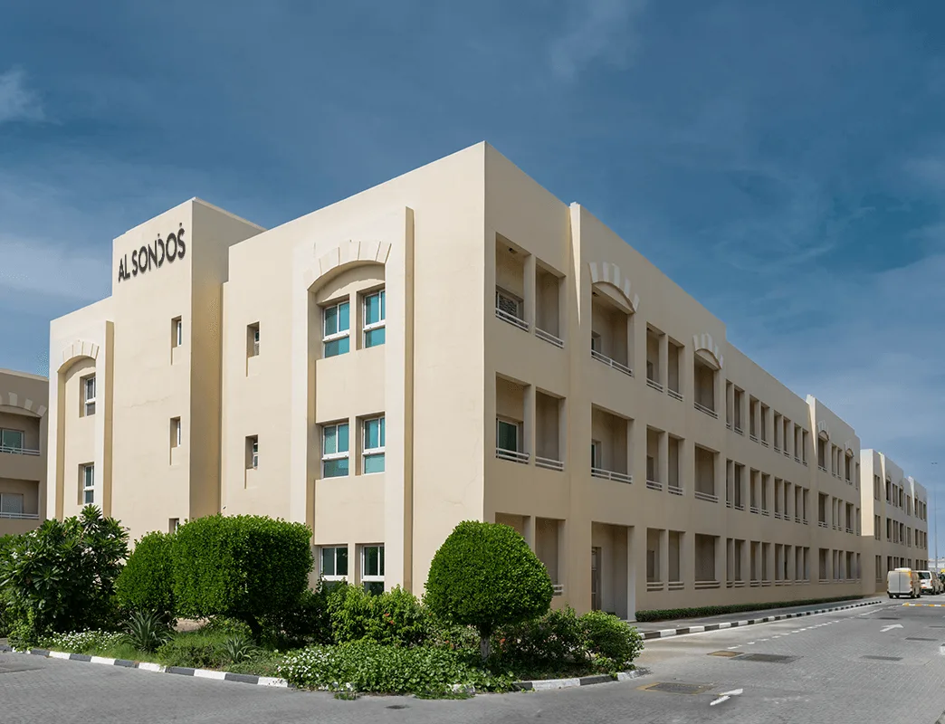 Three-storey beige block with arches and balconies