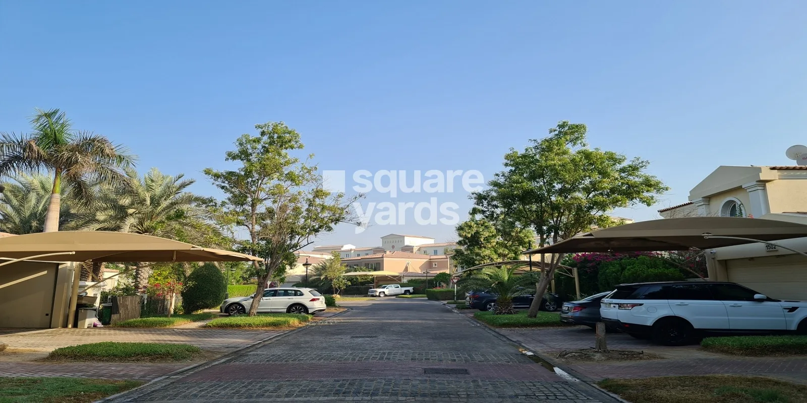 Green Community West street with villas and shaded parking