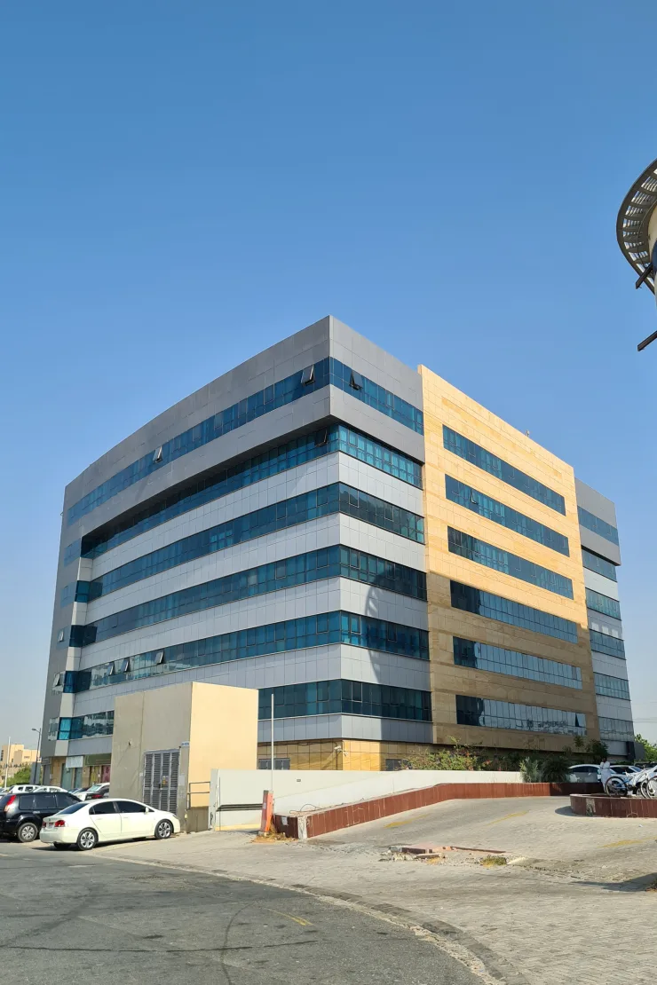 Rear and side facade, grey and tan panels