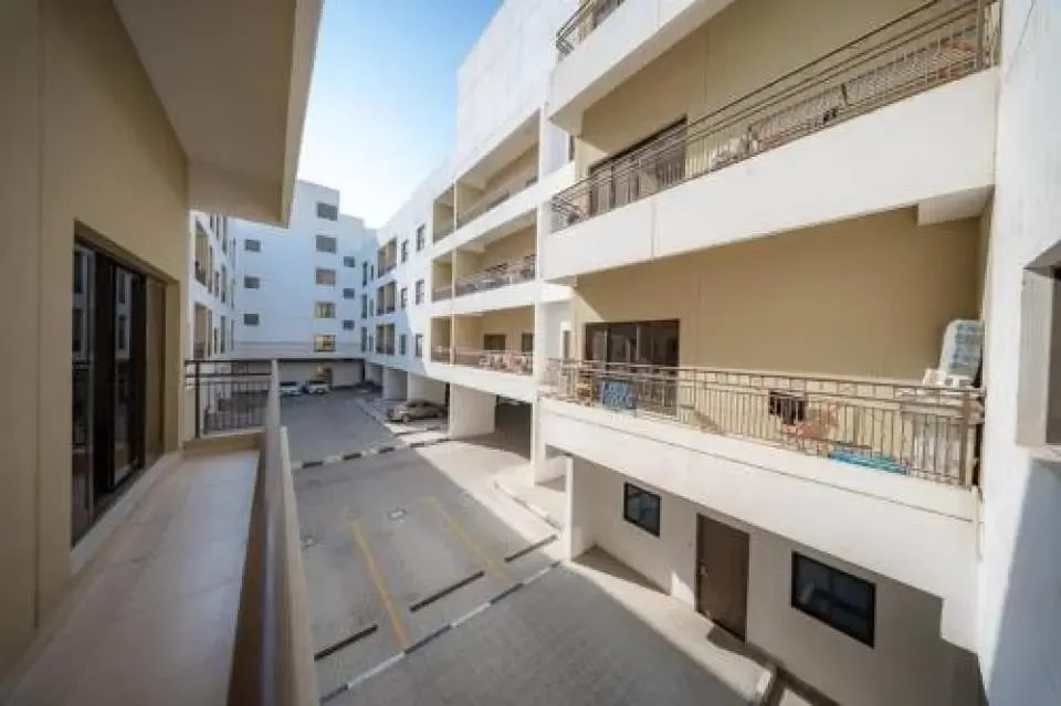 Courtyard view of white blocks with recessed balconies