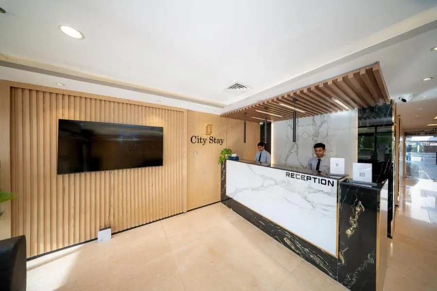 Reception desk with City Stay signage