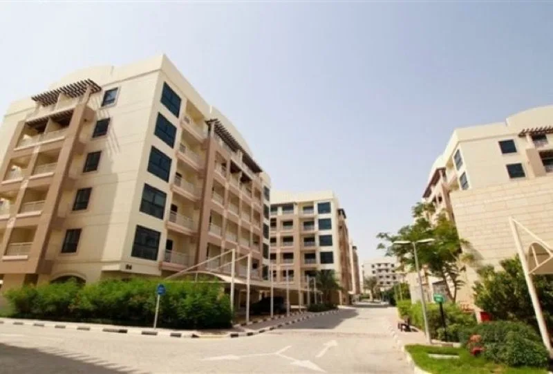 Cream mid-rise apartment blocks with balconies and pergolas