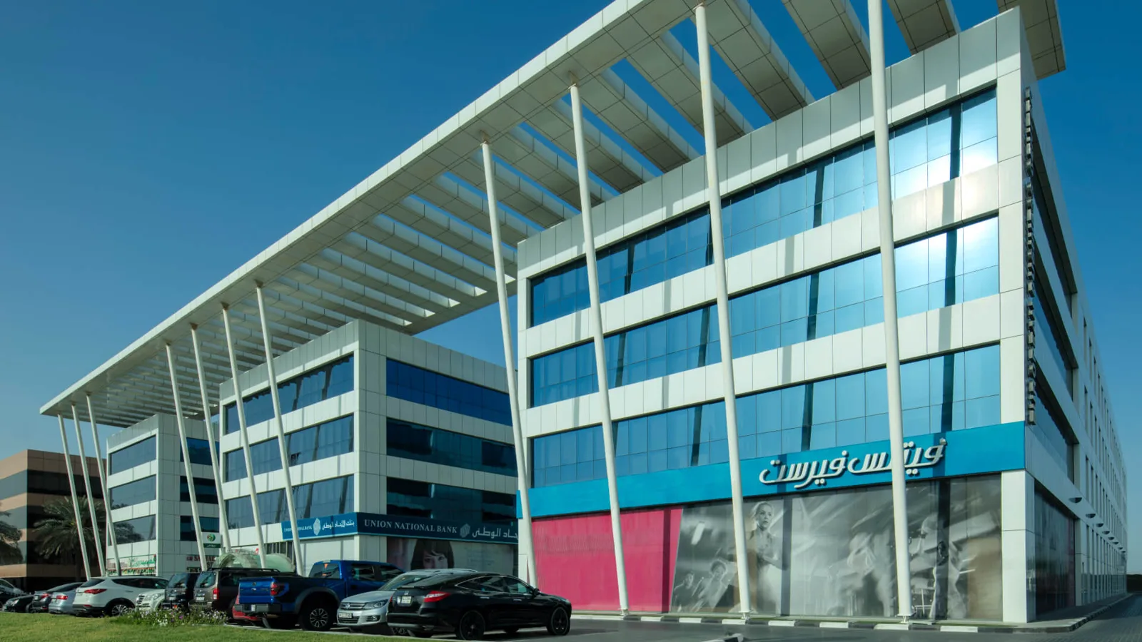 Corner of building with canopy and white columns