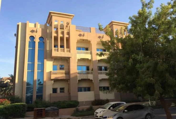 Four-storey sandstone building with blue glazed tower windows