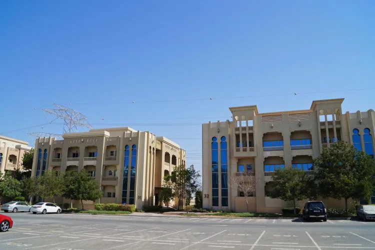 Two low-rise Ewan blocks with matching blue-glass facades
