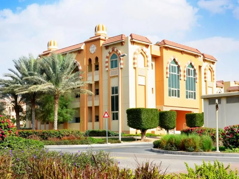 Orange Arabic-style low-rise with domes and tiled roofs
