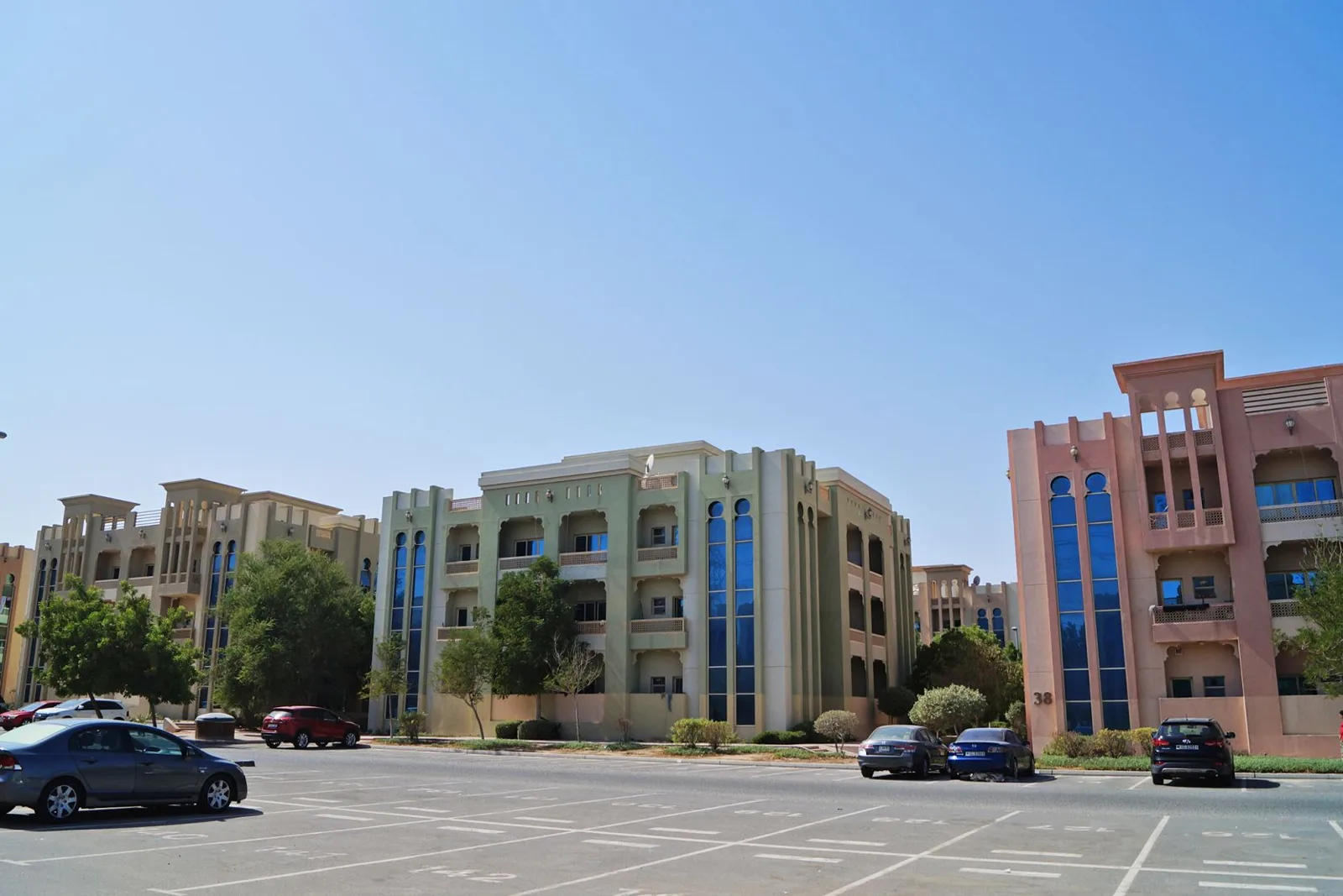Three-storey Arabic-style blocks with blue arched windows