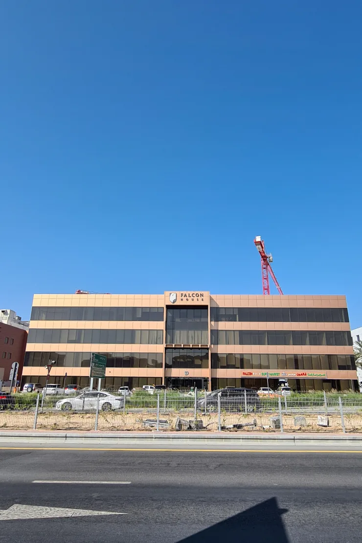 Front facade across road; crane visible behind