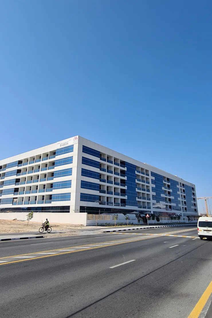 White and blue glass apartment block from the street
