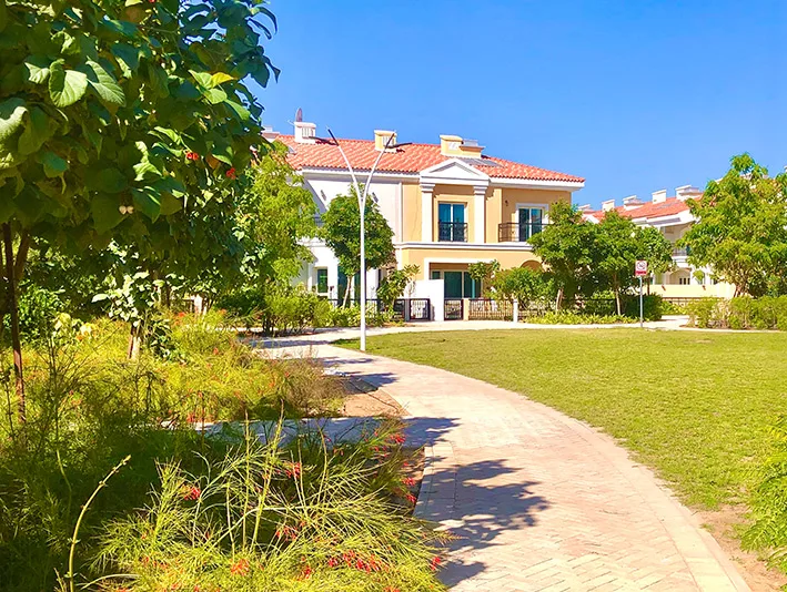 Townhouse seen across a landscaped park path