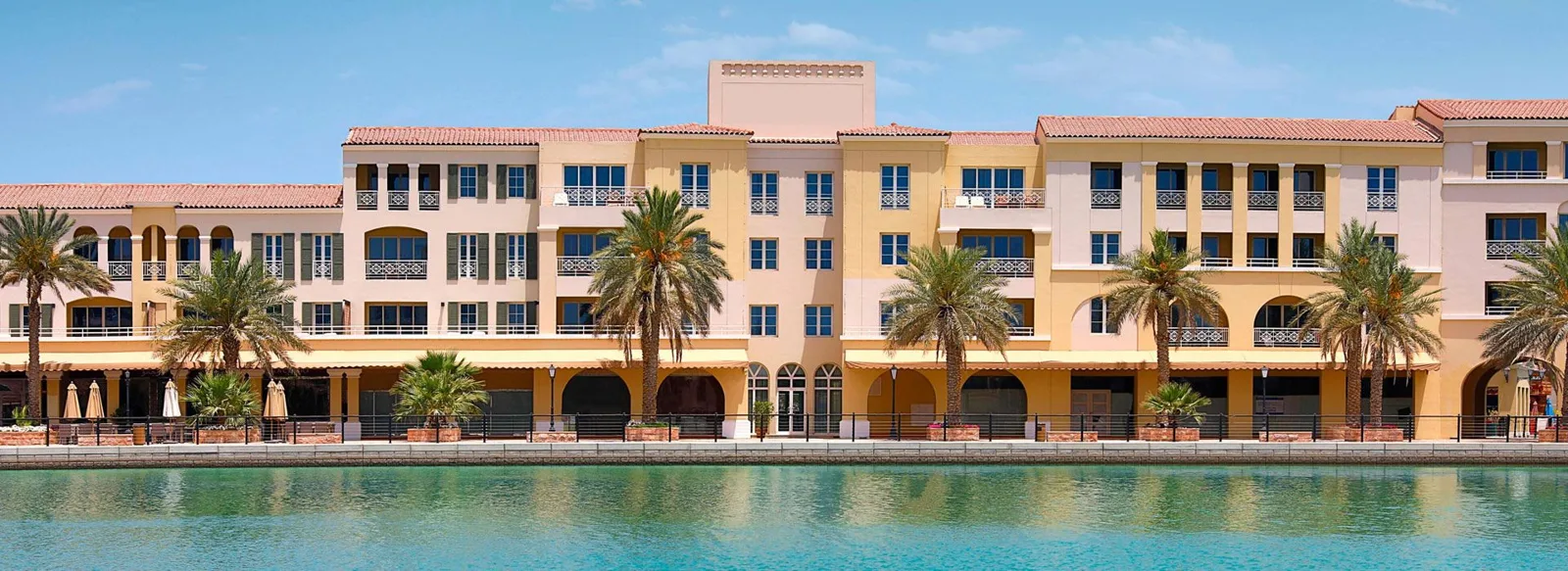 Lakeside Mediterranean-style apartment block with terracotta roofs