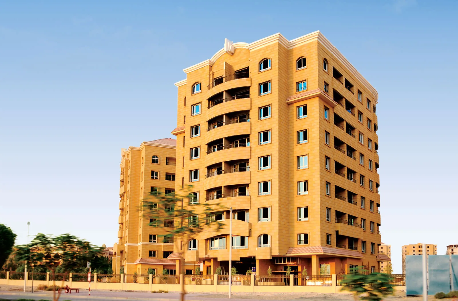 Sandstone tower with curved balconies, full height