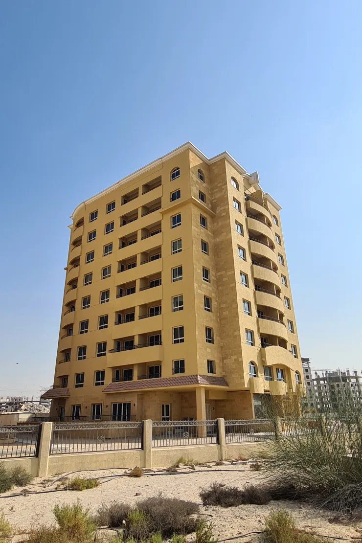 Full yellow sandstone tower with curved balconies