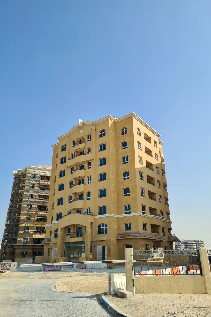 Beige tower with arched windows and pediment crown