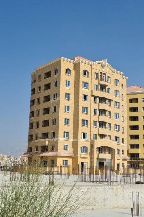 Beige tower, arched windows, pediment crown, side view