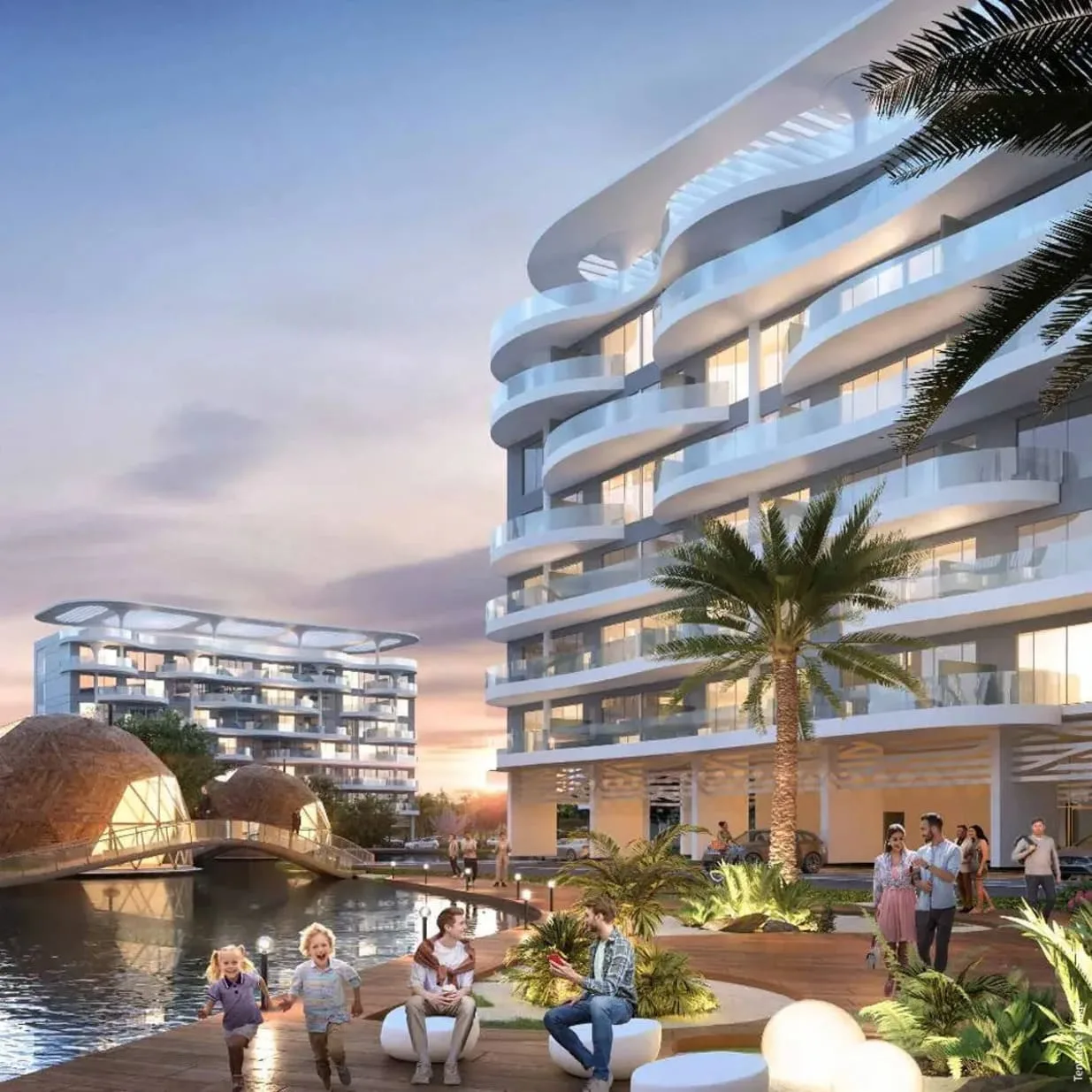 White curved-balcony building beside lagoon at dusk