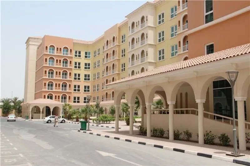 Peach and yellow arched balconies beside the arcade