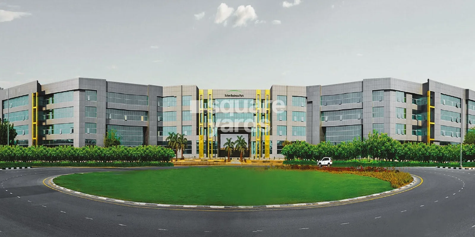 Full front facade across roundabout, landscaped