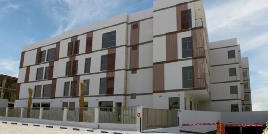 Low-rise white and brown building with wooden fins