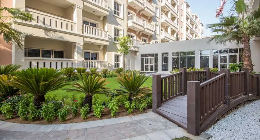 Garden with wooden bridge beside the residential blocks