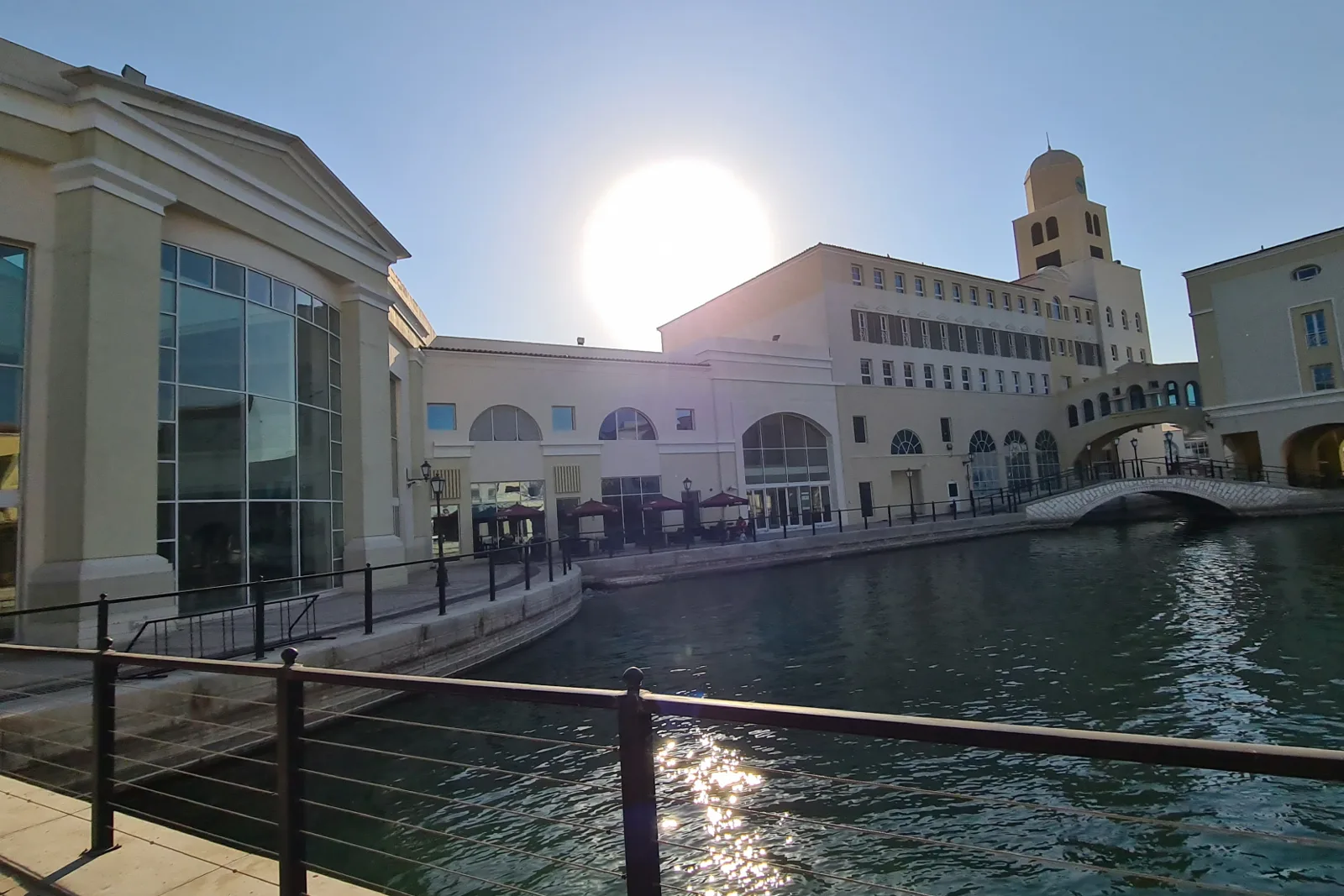 Canal-side facade with arched windows and clock tower