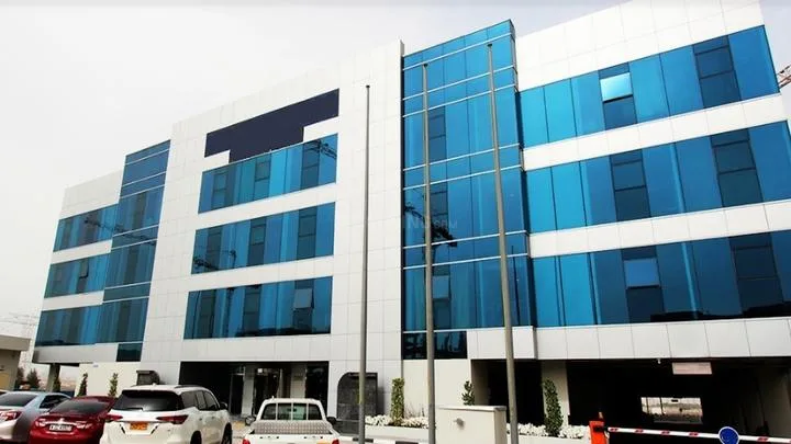 Blue glass and white panel mid-rise office-style building
