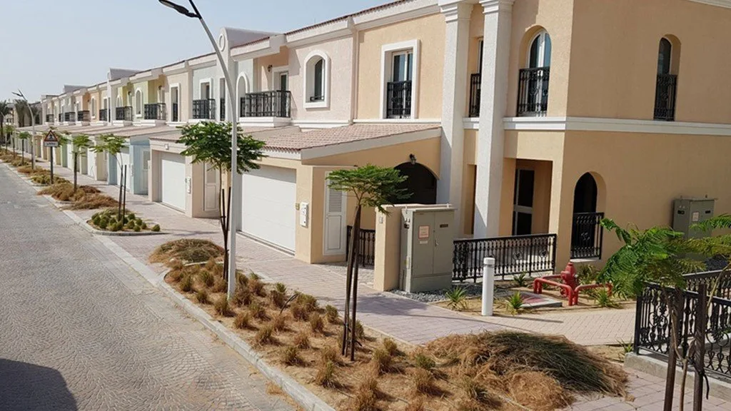 Row of two-storey townhouses along a street