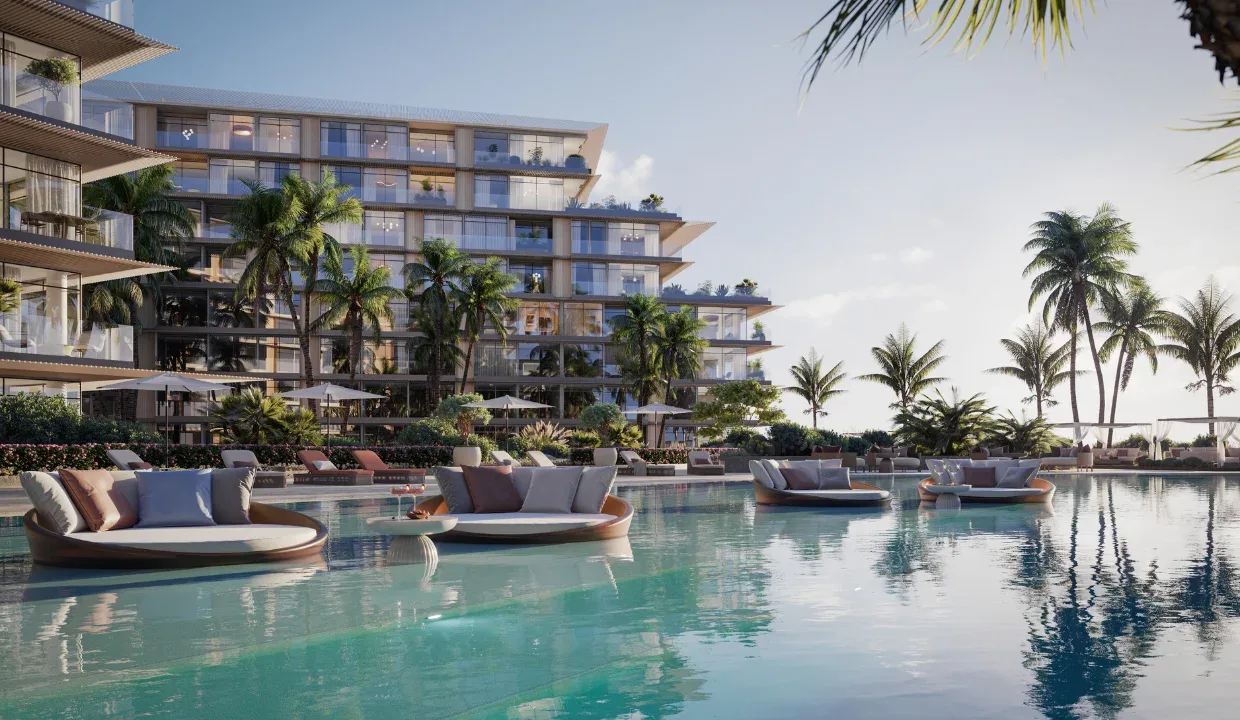 Residence facade rising above the lagoon pool and daybeds