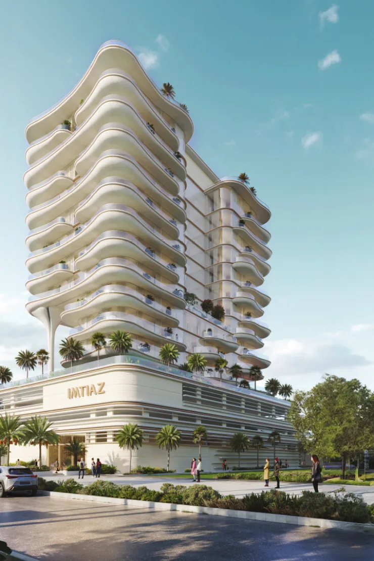 Street-level view of wavy-balcony tower and podium