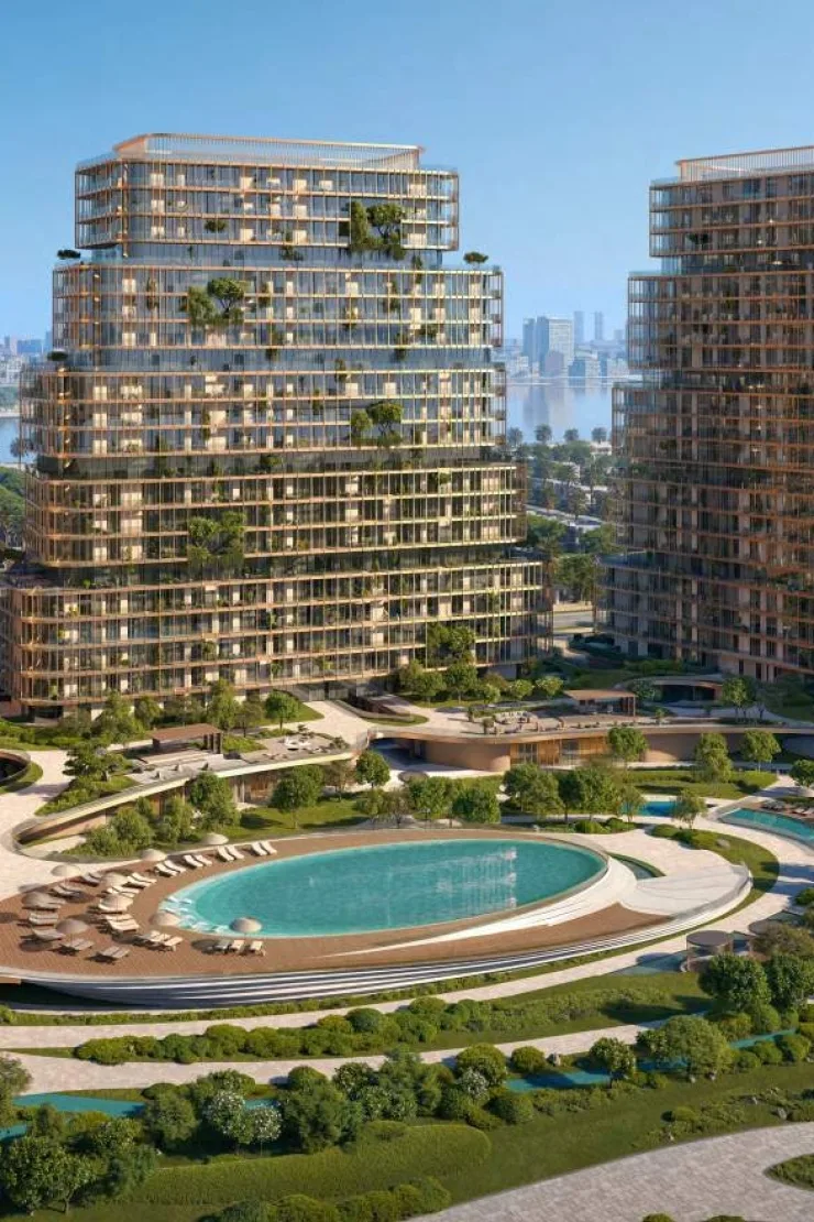 Tower with gold bands and greenery above pool
