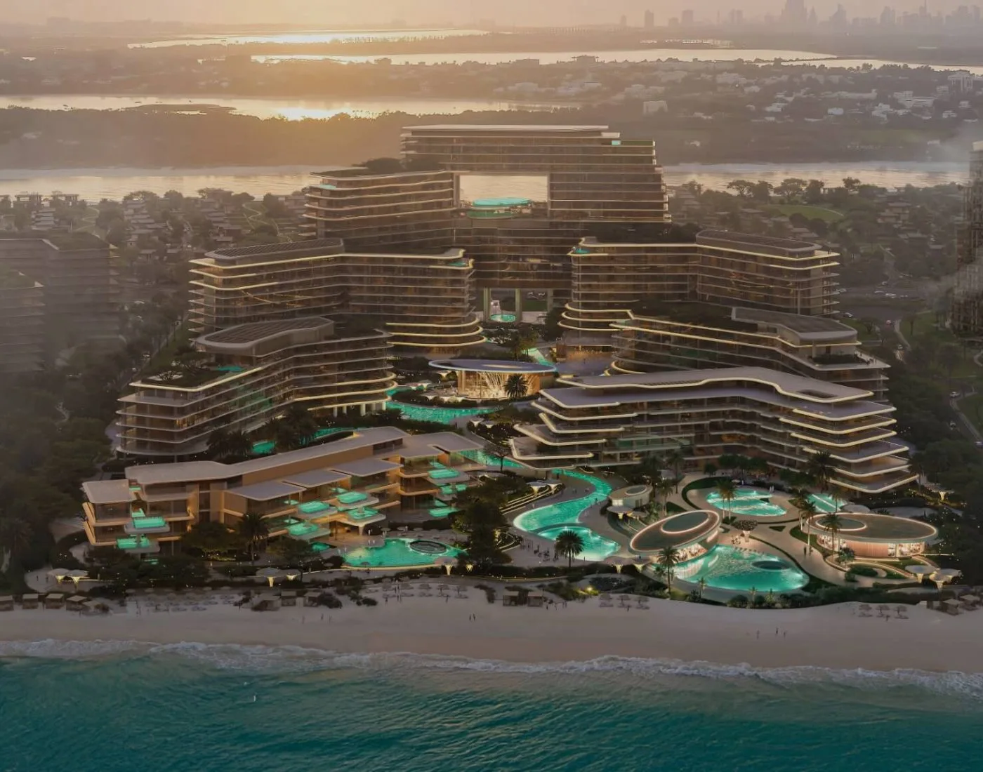 Aerial render of the beachfront complex at sunset