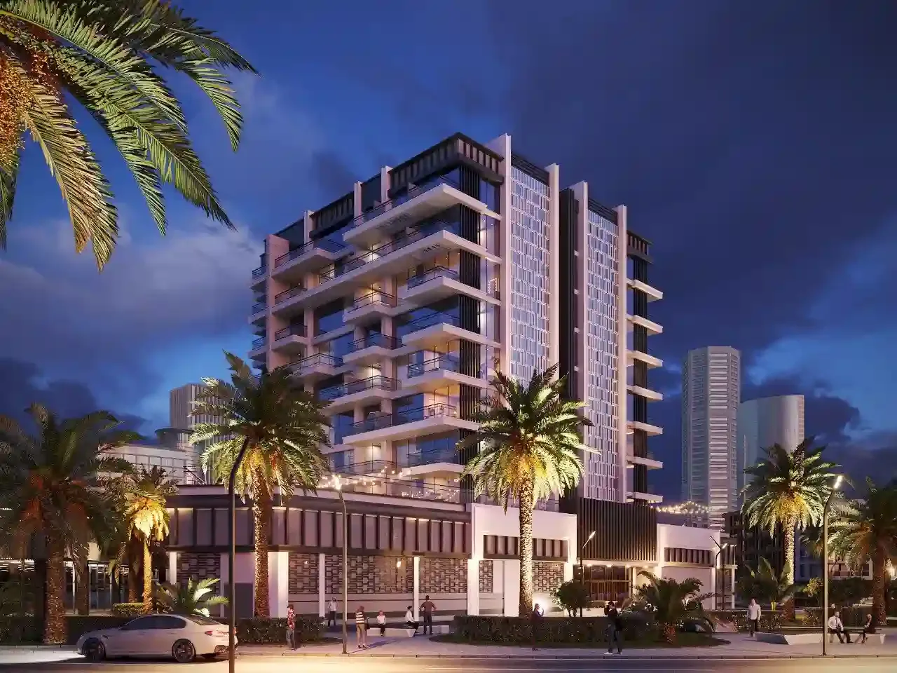 Dusk view of tower and podium with palms