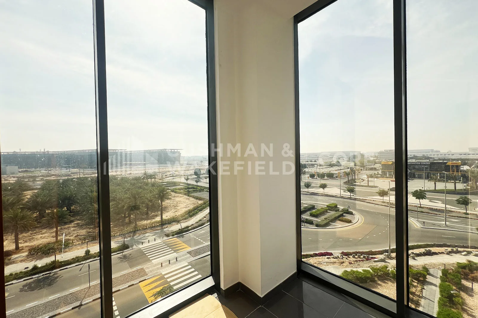 Corner window view over Dubai South roads and landscaping
