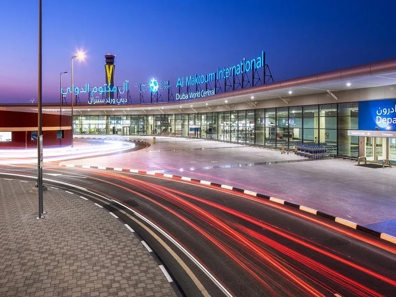 Al Maktoum International terminal entrance at dusk, with signage