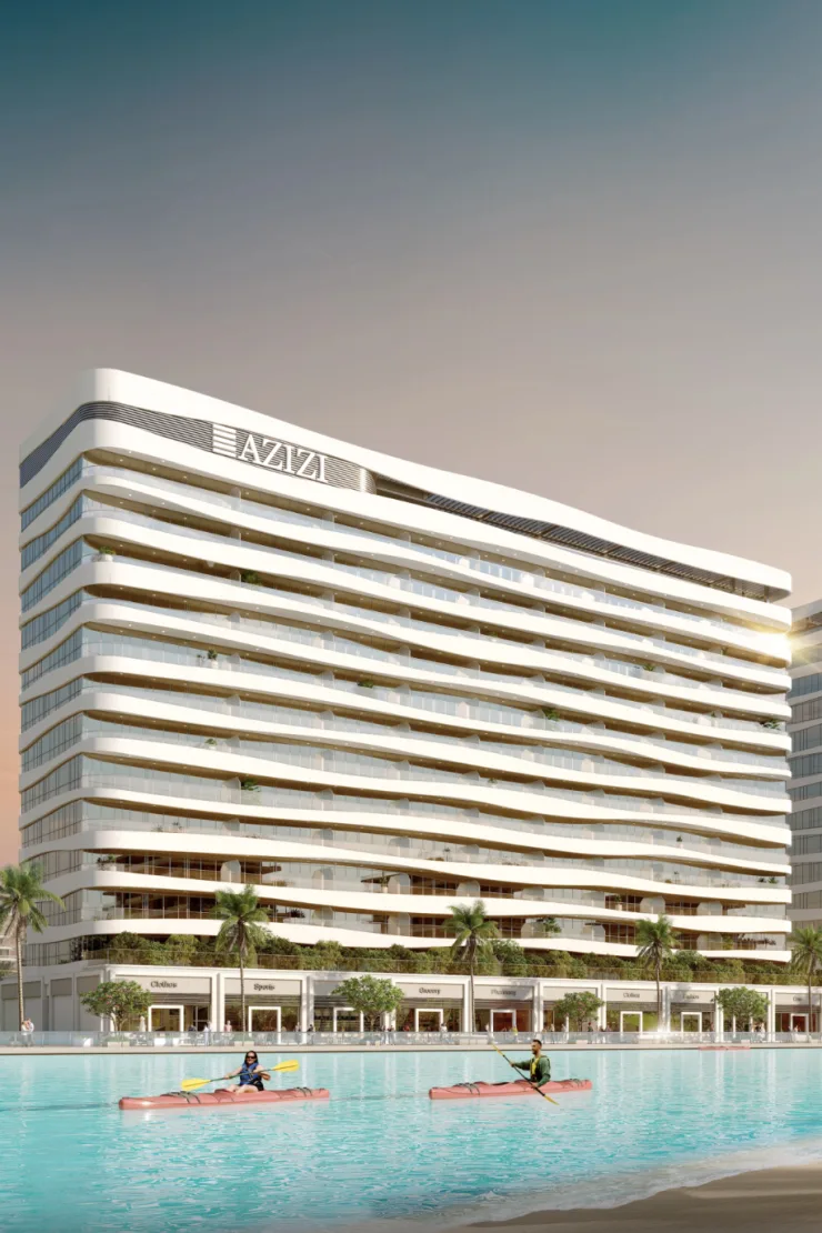 White wavy-balcony Azizi tower beside the lagoon