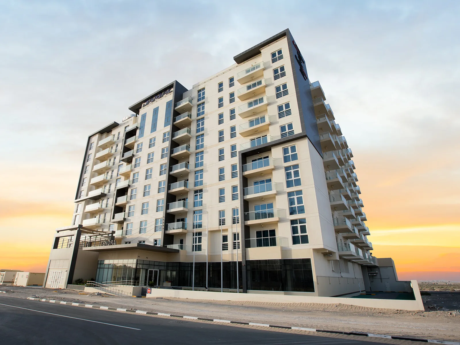 Full tower exterior at sunset with Tenora entrance
