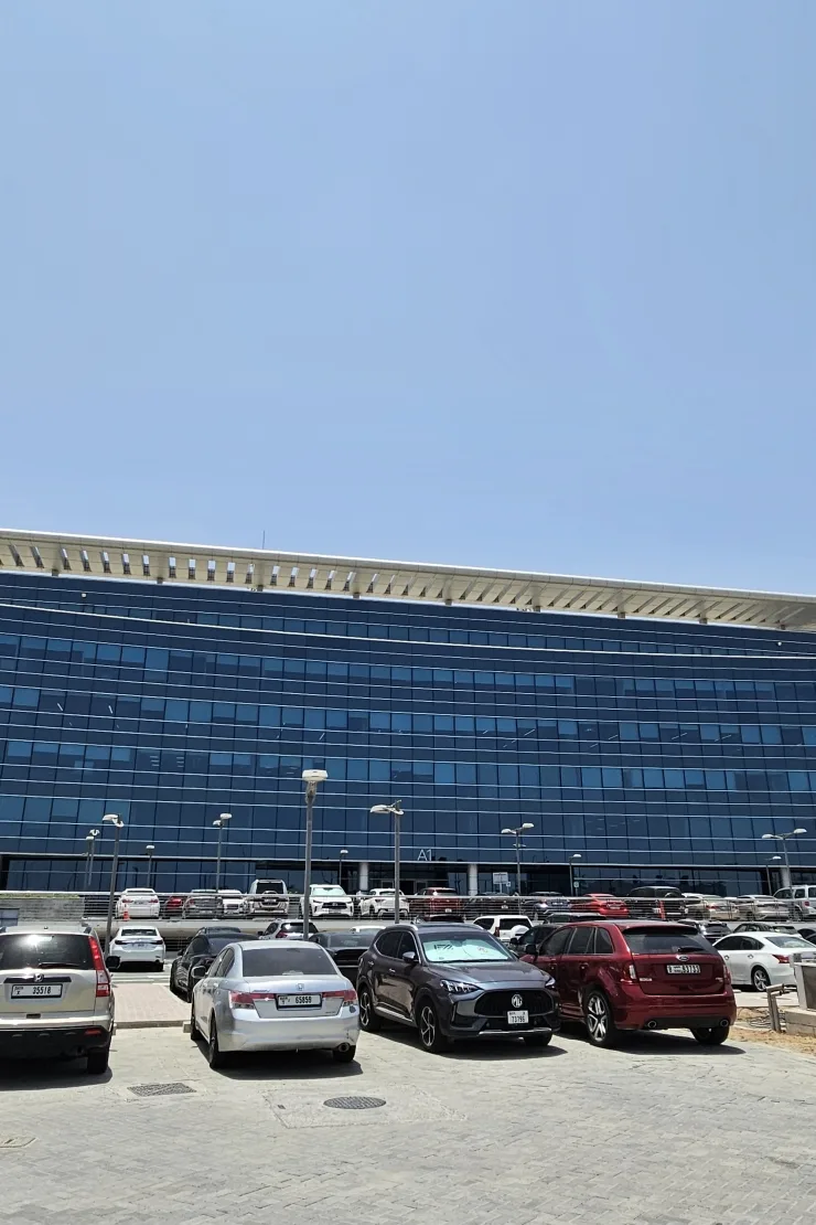 Blue glass office facade with canopy roof, marked A1