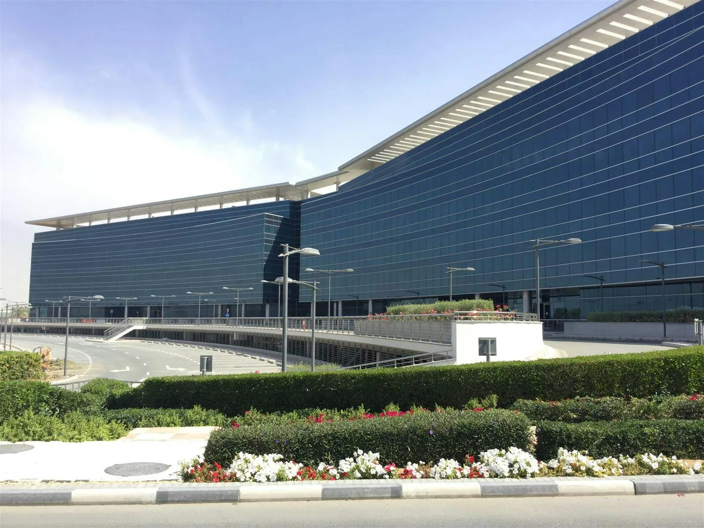 Blue glass business park building with overhanging roof