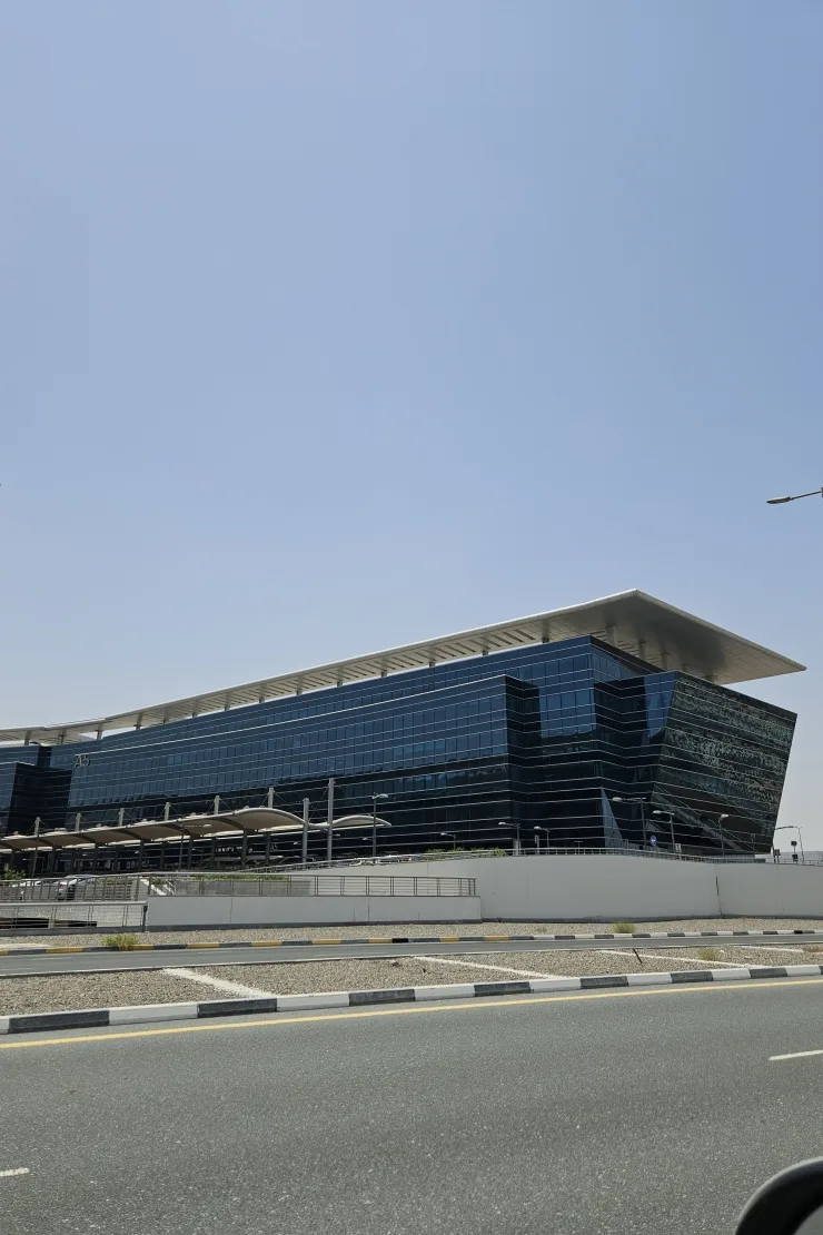 Dark glass office building with large overhanging roof canopy