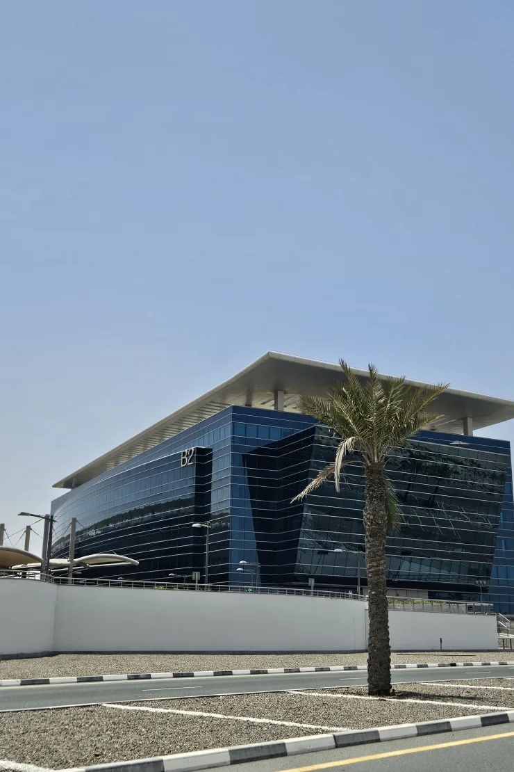 Blue glass B2 building with overhanging roof canopy