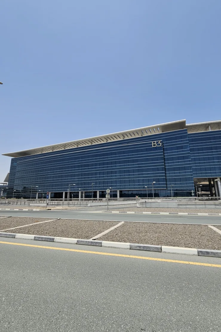 Blue glass office building with B3 signage