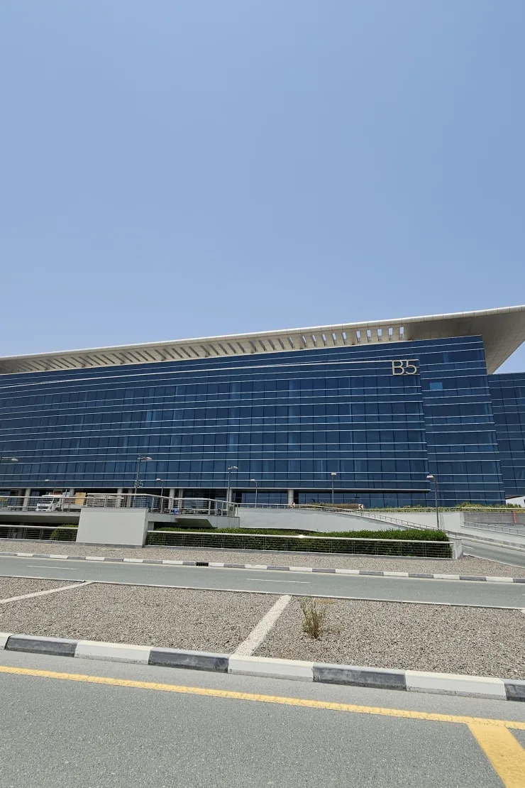 B5 signage on blue glass facade with wide canopy roof