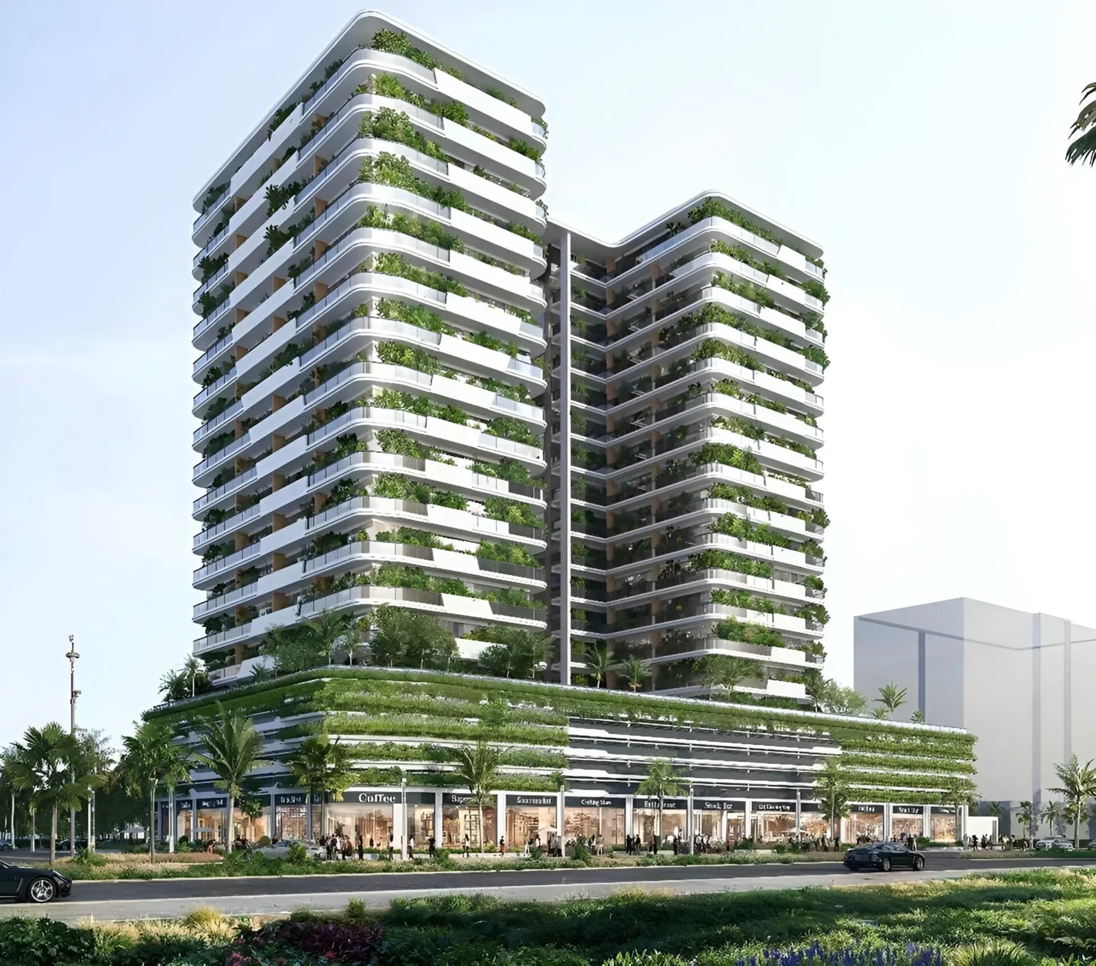 Twin-block tower with planted balconies, podium shops