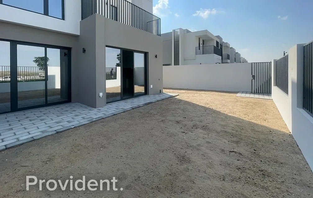 Villa rear garden and facade with neighbouring townhouses