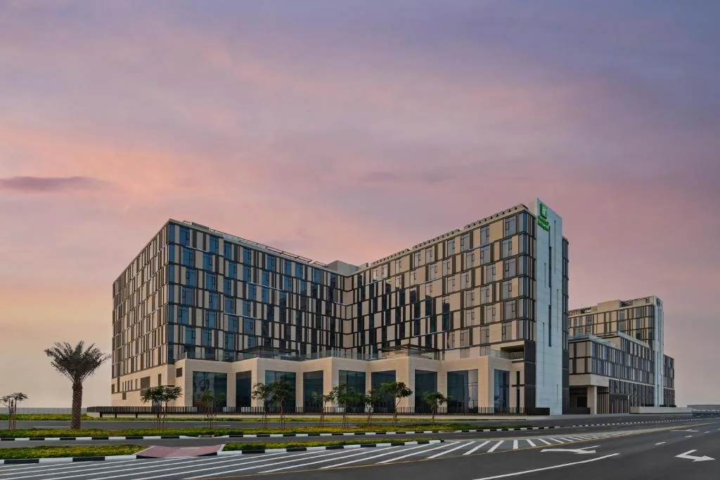 Full hotel exterior at dusk, ground to roof