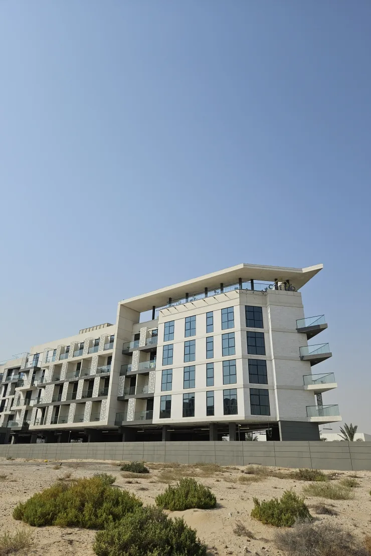 Side view of completed building, cantilevered roof, glass balconies