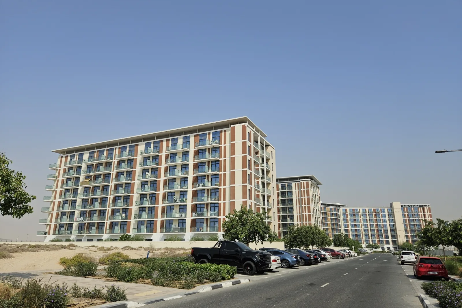Completed residential blocks with brick-toned facade and balconies