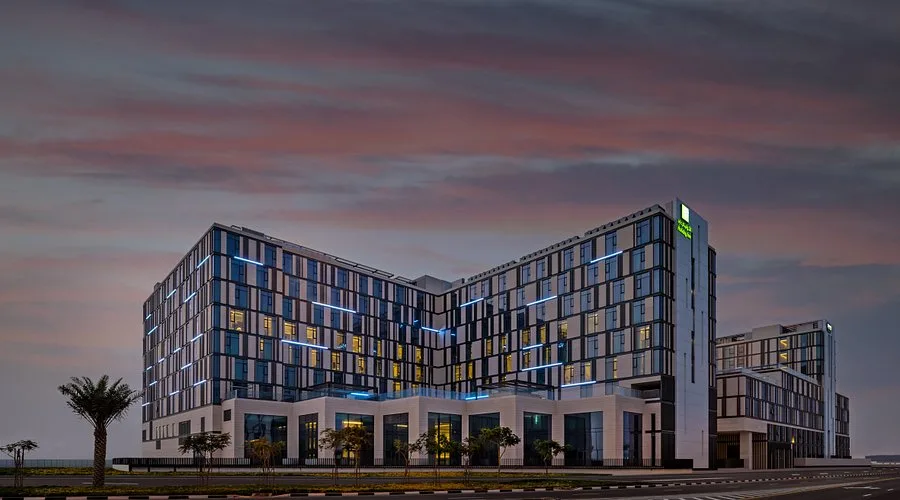 Hotel exterior at twilight with blue lighting