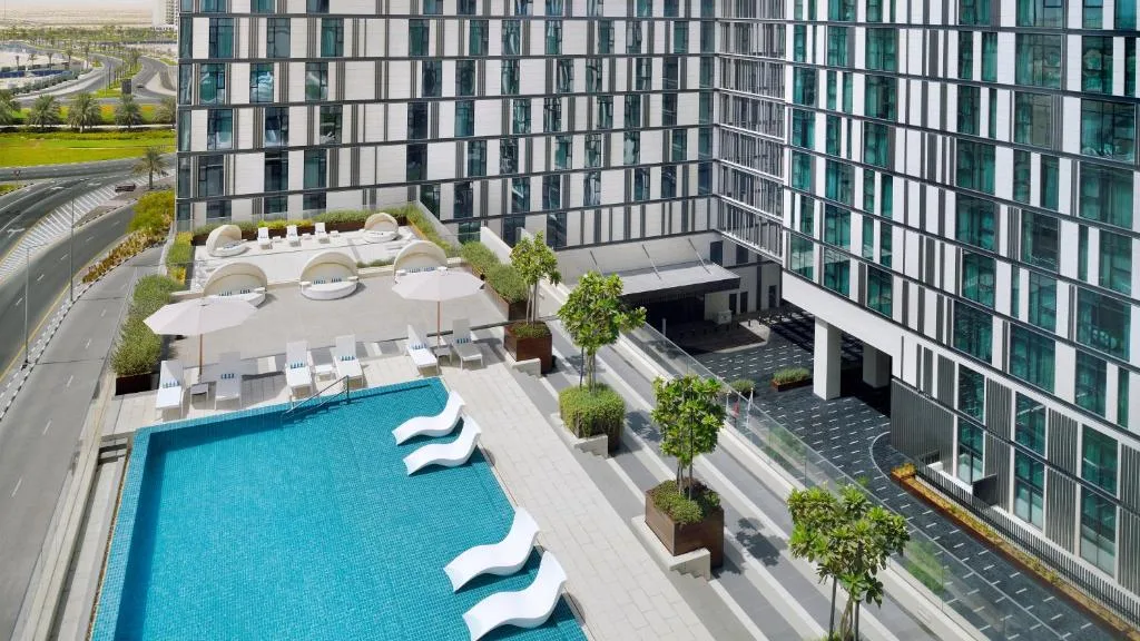 Rooftop podium pool deck beside the hotel facade